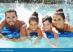 A family is laying on a raft in a swimming pool