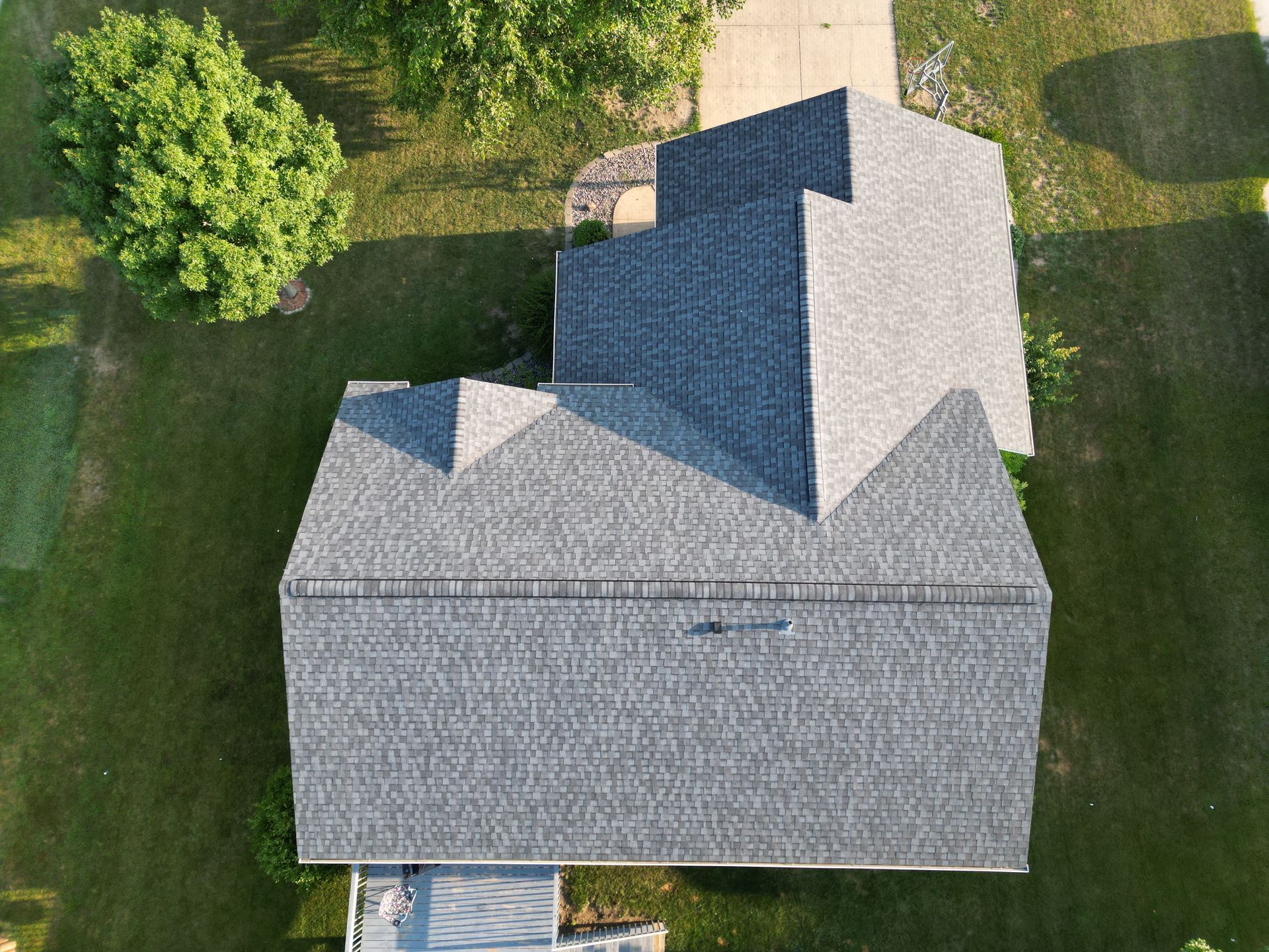 An aerial view of a house with a gray roof.