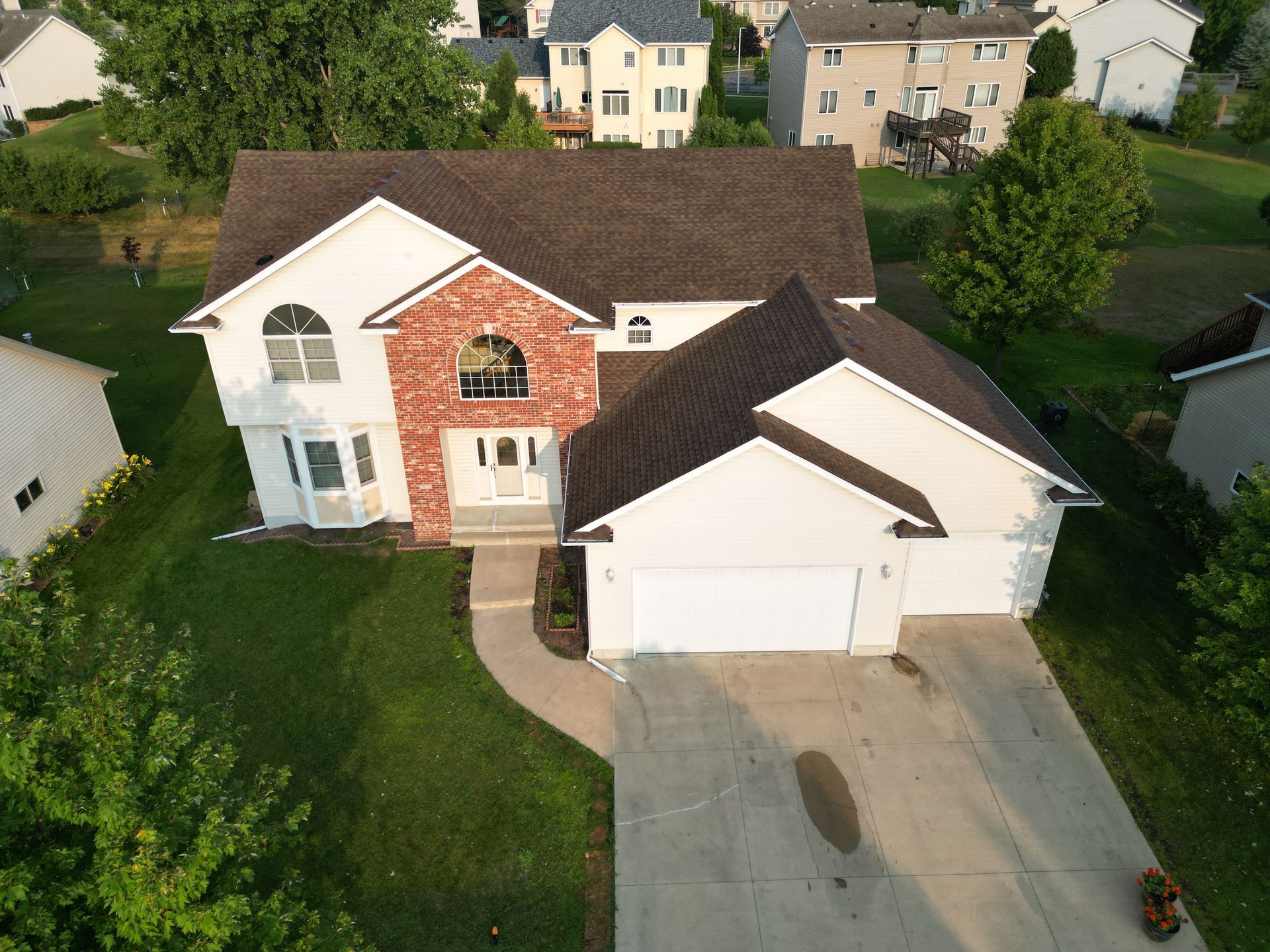 An aerial view of a house with a brown roof