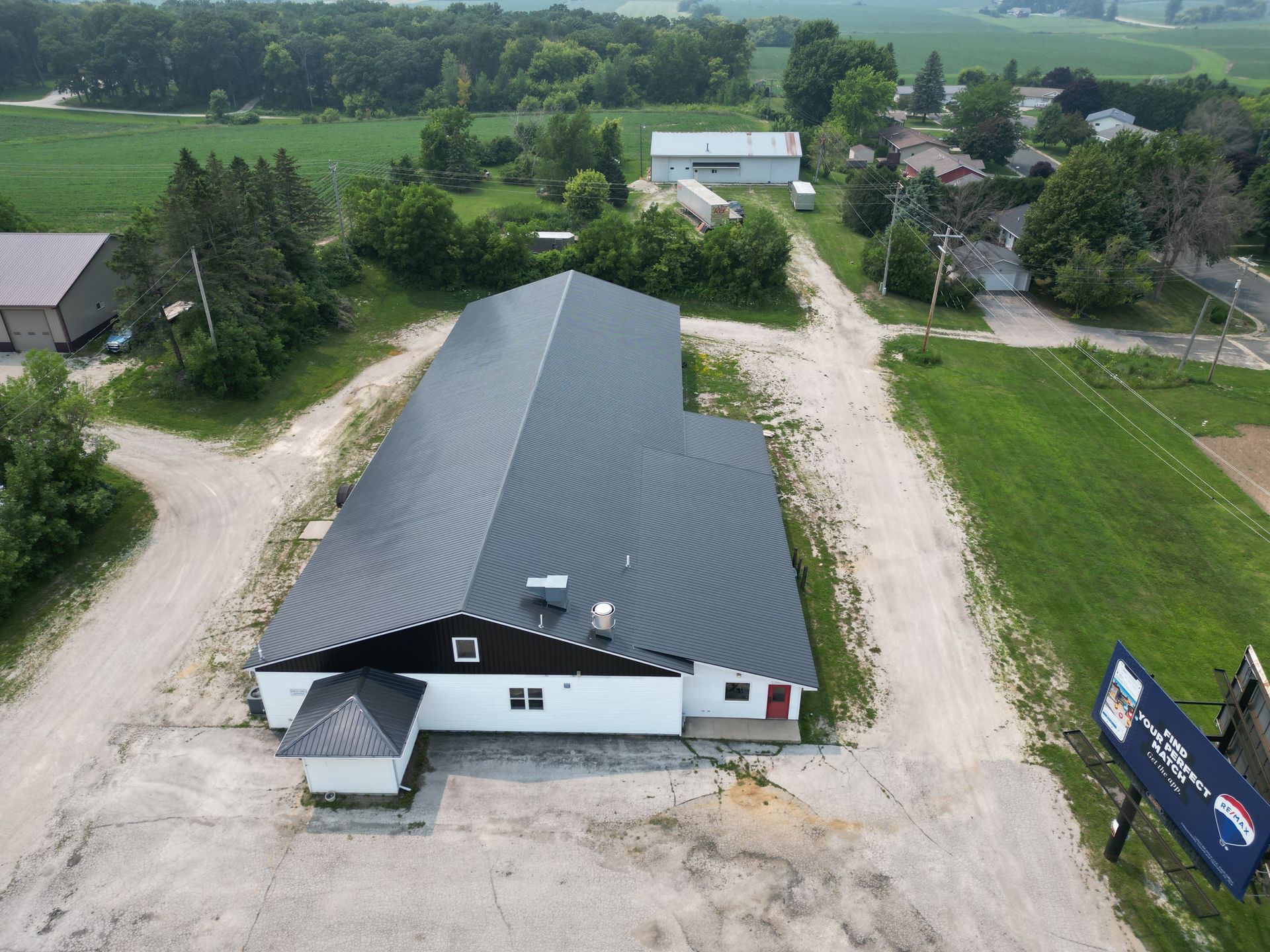 An aerial view of a large building in the middle of a field