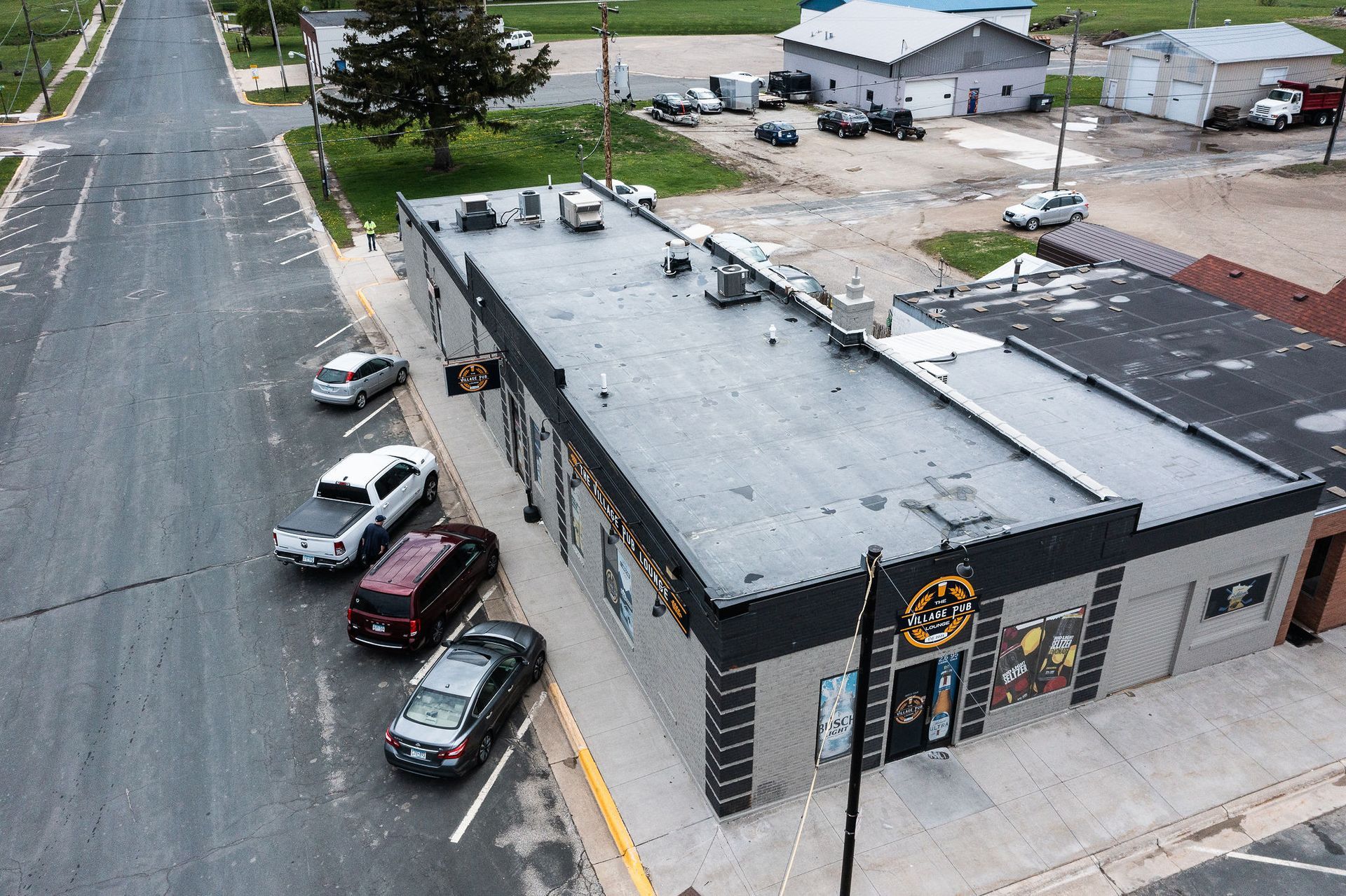 An aerial view of a building with cars parked in front of it