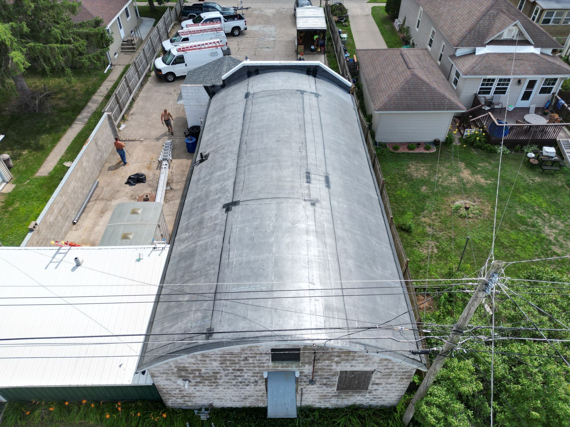 An aerial view of a building with a roof that is being installed.