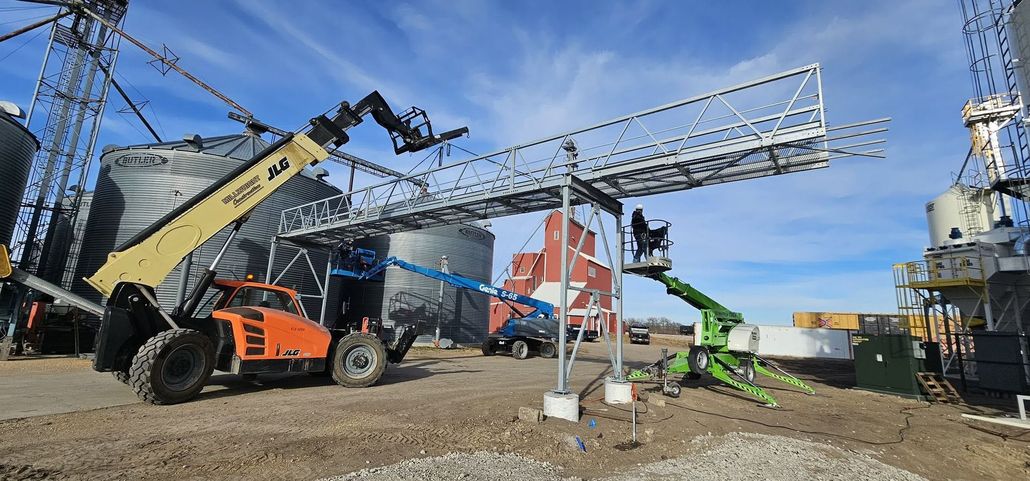 Construction site with tower crane and steel framework under a blue sky