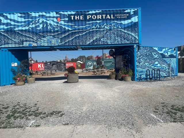 Blue shipping containers form an entrance to