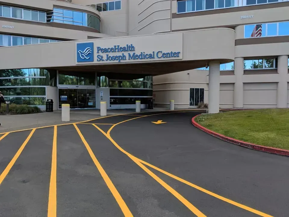 Entrance to PeaceHealth St. Joseph Medical Center with drive-up access and signage.