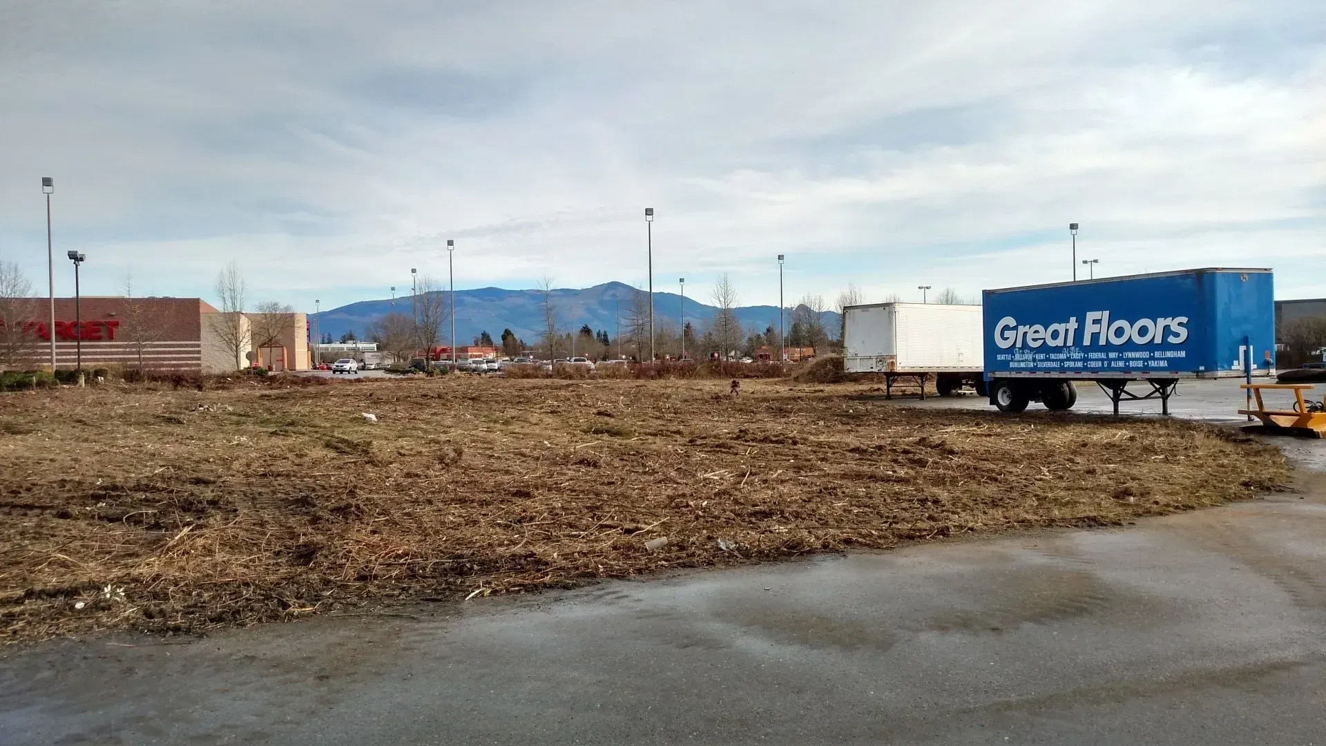 Cleared lot with debris, trailers, and