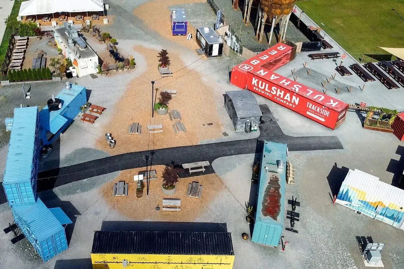 Overhead view of a miniature town with buildings, vehicles, and the red and white