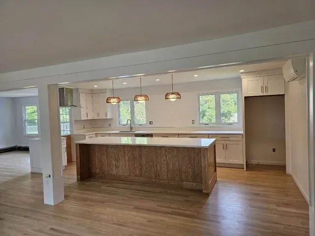 There is a large island in the middle of the kitchen.