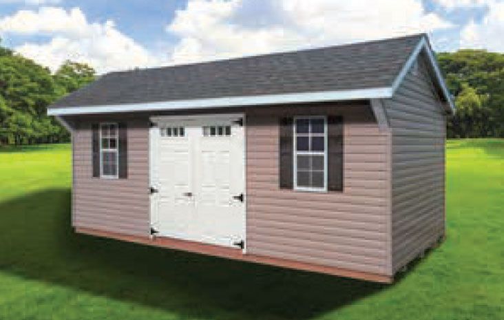 Brown shed with white doors, black shutters, and a dark roof on green grass.
