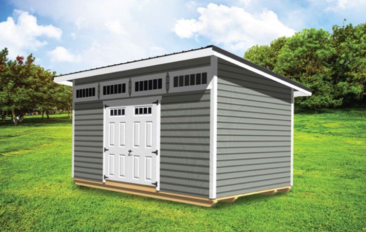 Gray shed with white trim, door, and vents, on a grassy lawn with trees and blue sky.