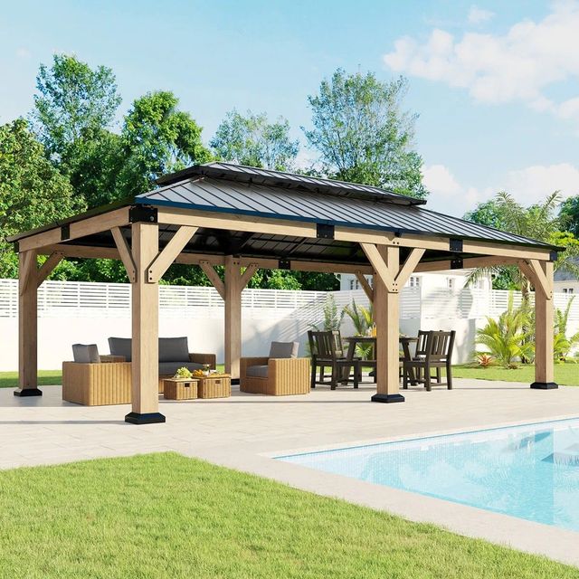 Wooden poolside pavilion with seating beside a swimming pool and green lawn