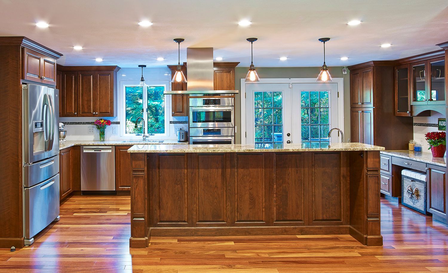 Spacious modern kitchen with wood cabinets, stainless steel appliances, and a large central island