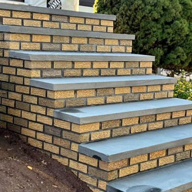 Brick stairs with gray concrete steps, outdoors.