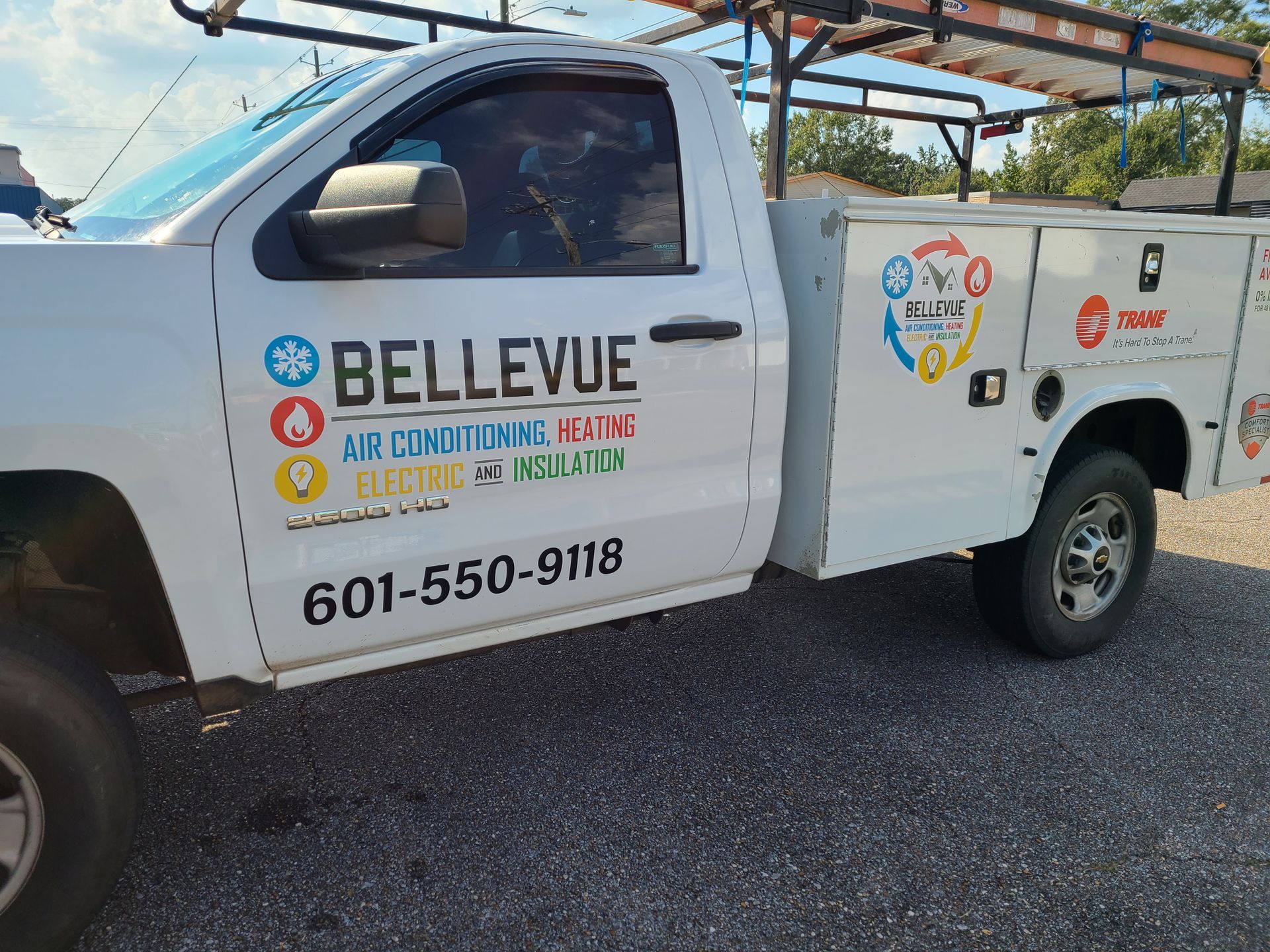 A white truck is parked on the side of the road.