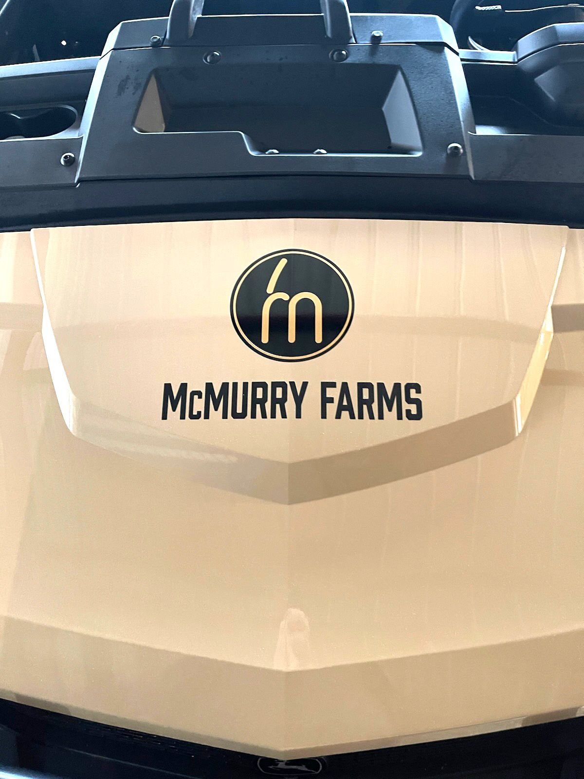 The hood of a vehicle with the logo for mcmurry farms on it