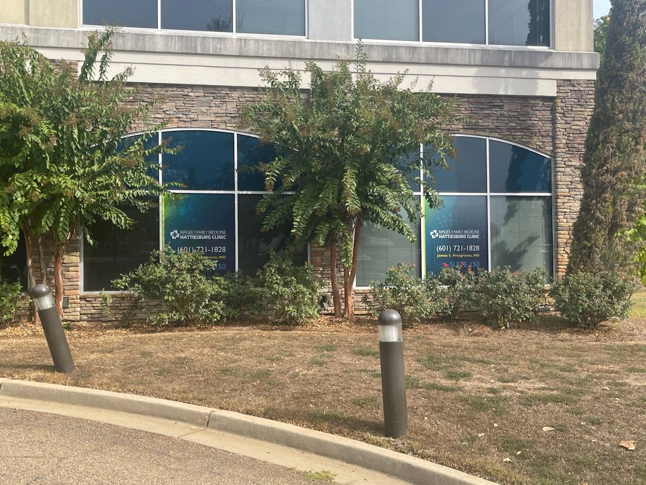 A building with a lot of windows and trees in front of it