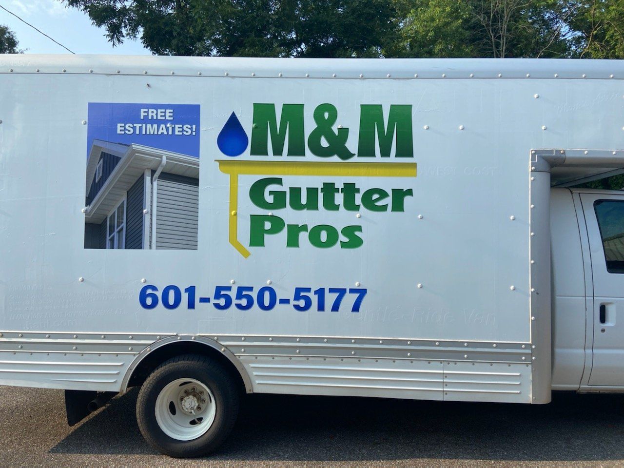 A m & m gutter pros truck is parked on the side of the road