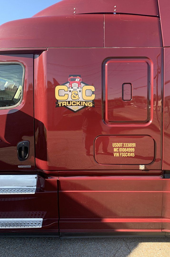 A red semi truck is parked on the side of the road.