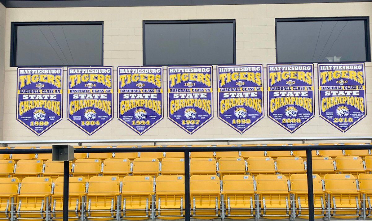 A row of tigers state champions banners hanging on a wall