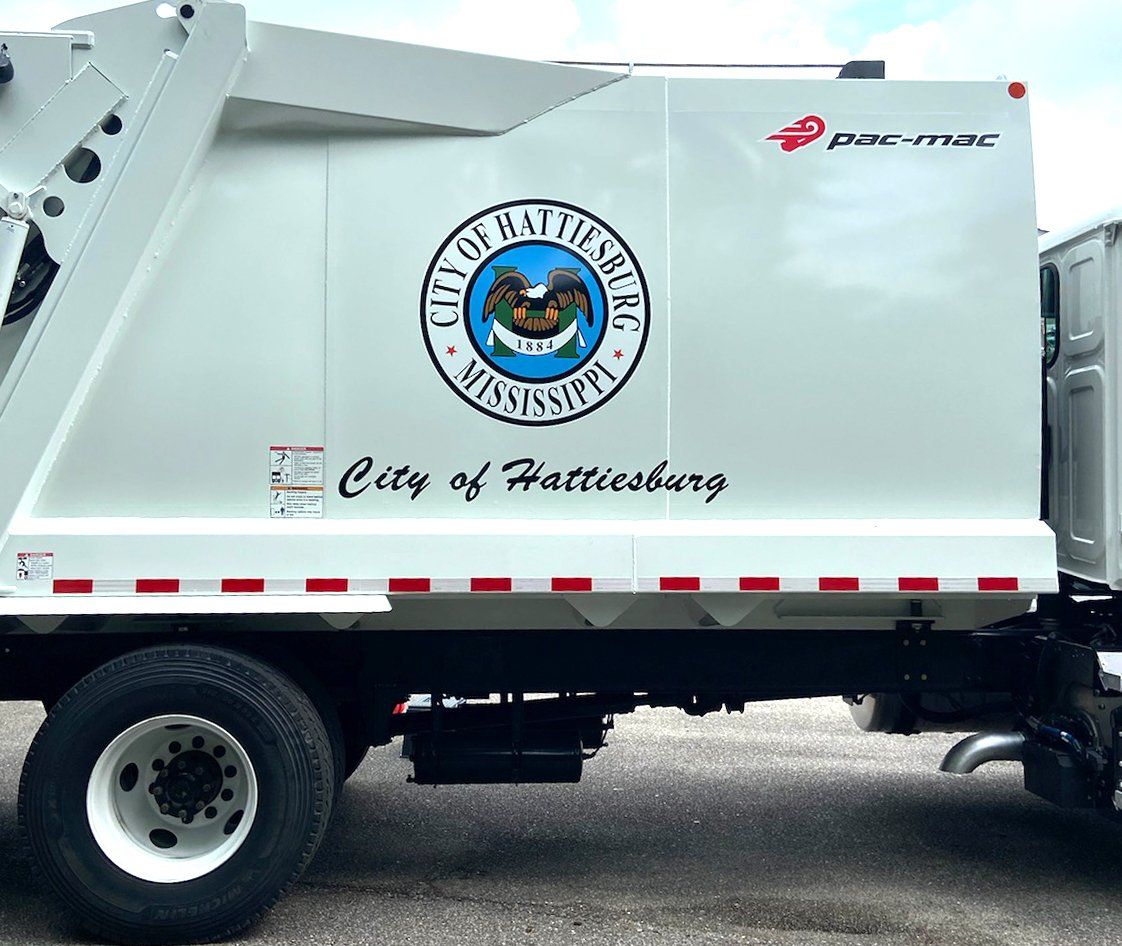 A white garbage truck from the city of pattiesburg