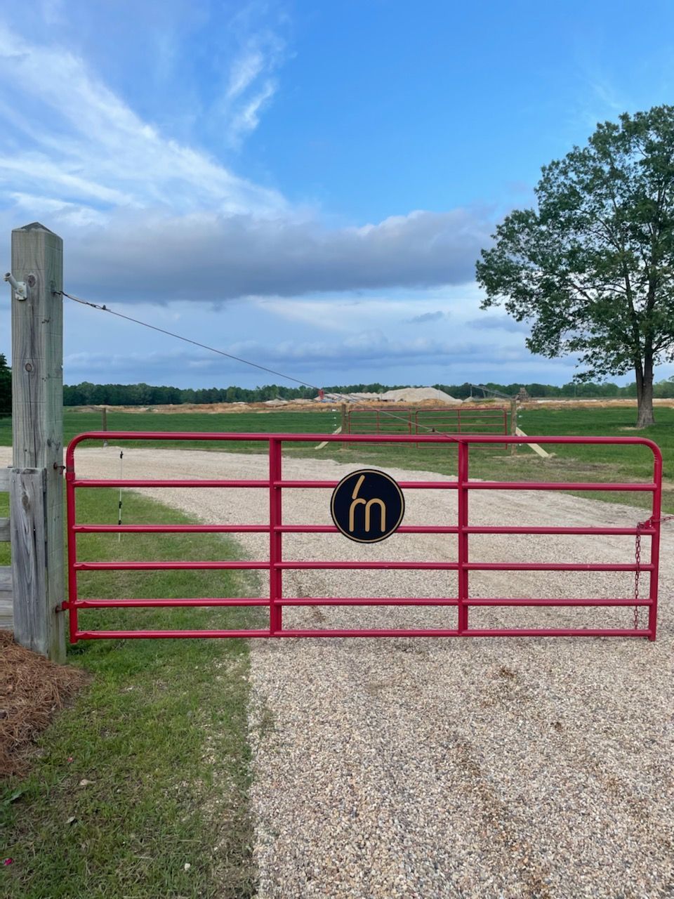A red gate with the letter m on it