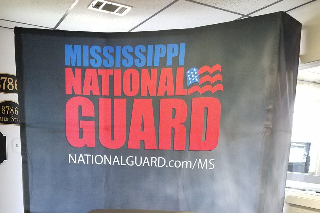 A mississippi national guard flag is hanging on a wall