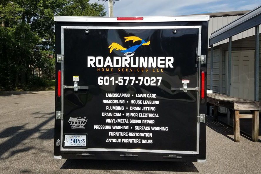 The back of a trailer that says roadrunner home services llc