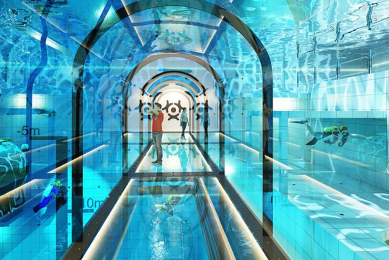 A tunnel leading to a swimming pool with people swimming in it.