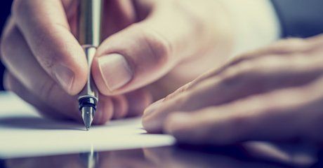 Writing on a paper using sign pen