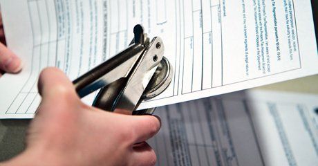 Punching notary stamps on paper