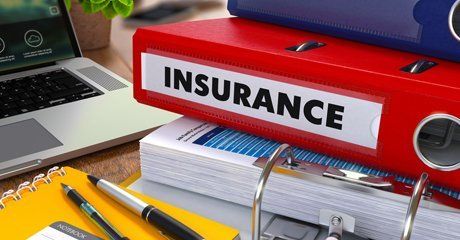Insurance folders and documents at the table