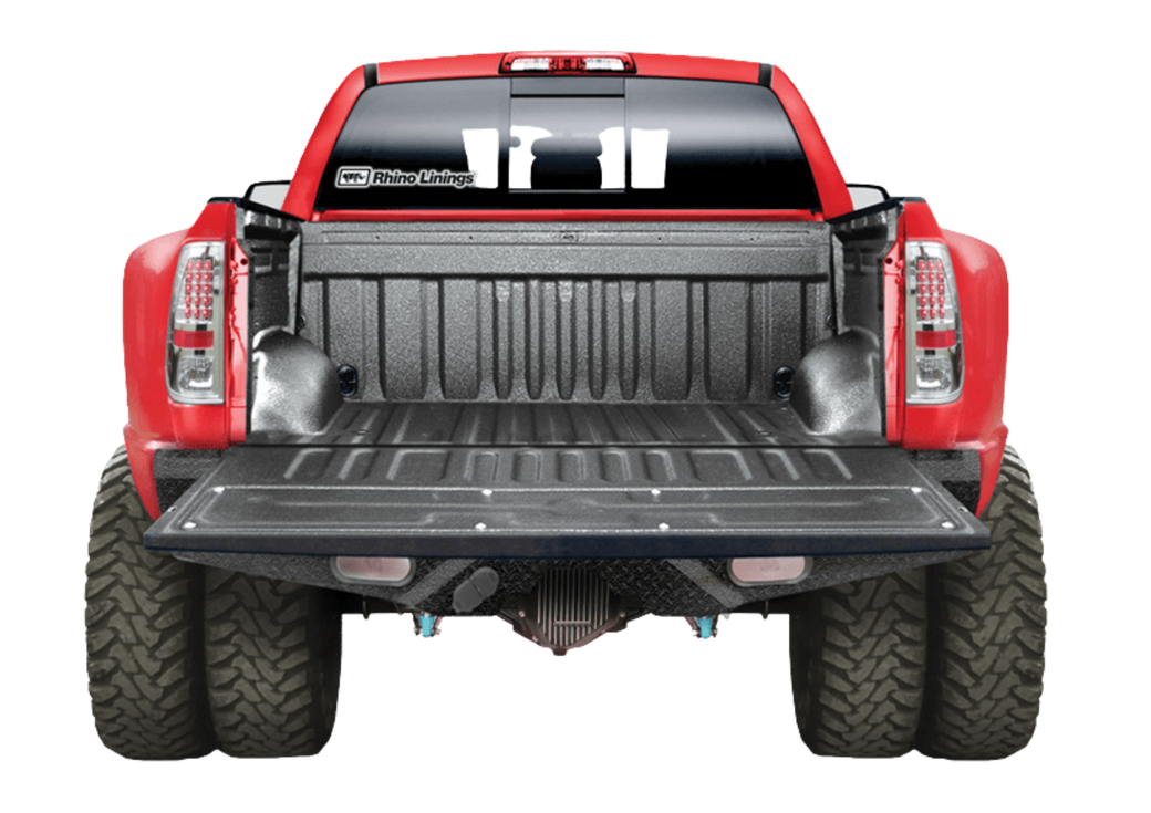 Red pickup truck with open tailgate, showing bed interior and dual rear tires.