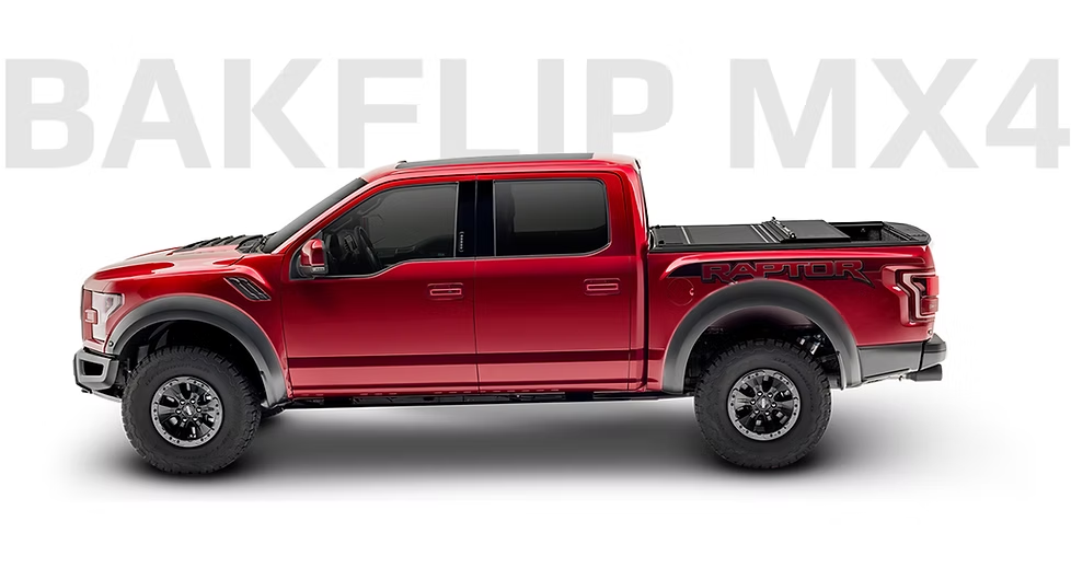 Red Ford Raptor pickup truck with a Bakflip MX4 tonneau cover.