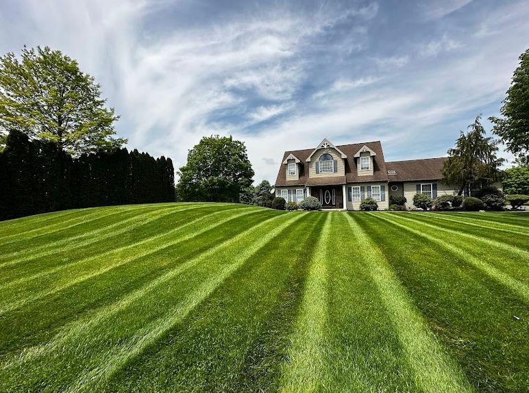A large house with a lush green lawn in front of it.