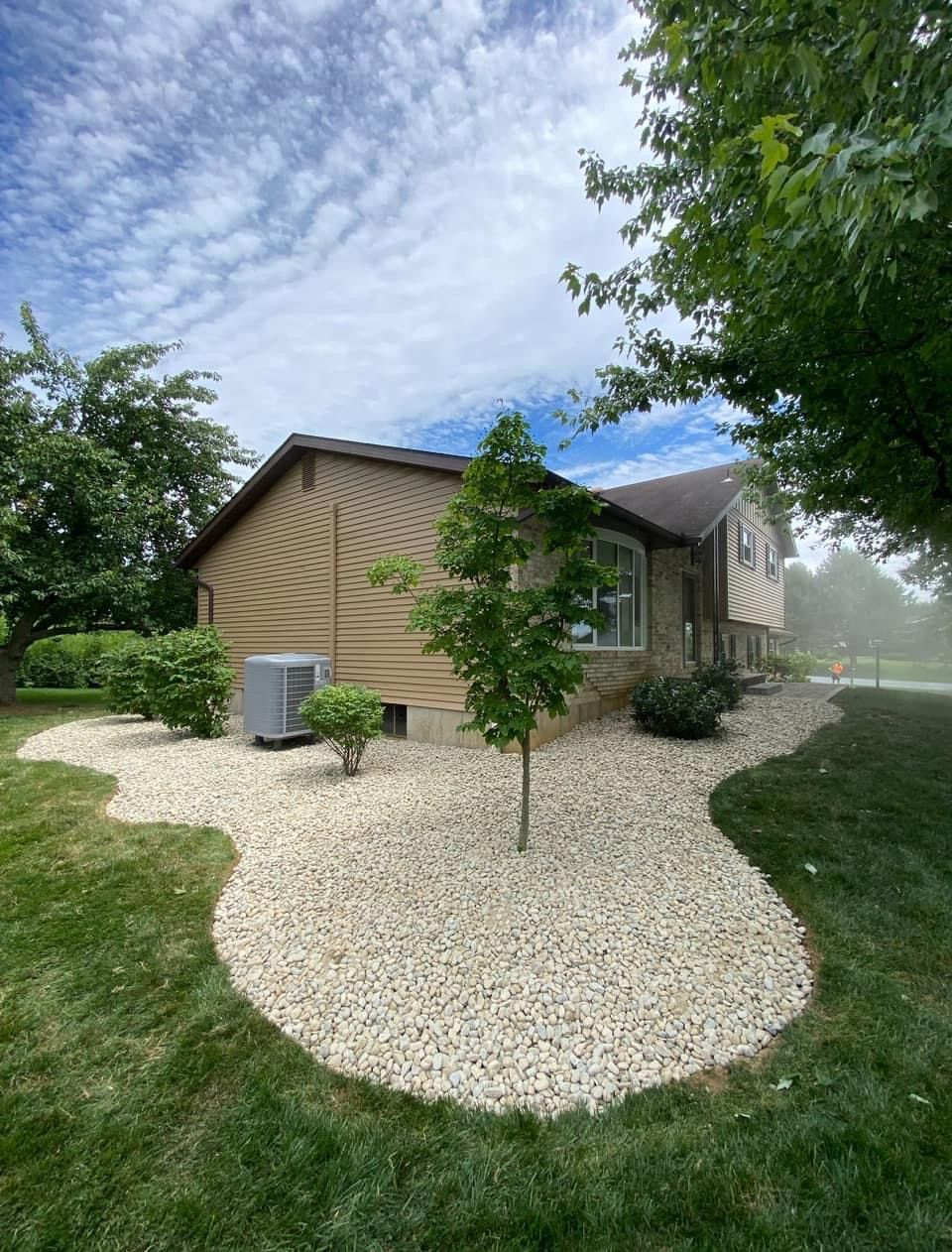 A house with a lot of gravel in front of it.