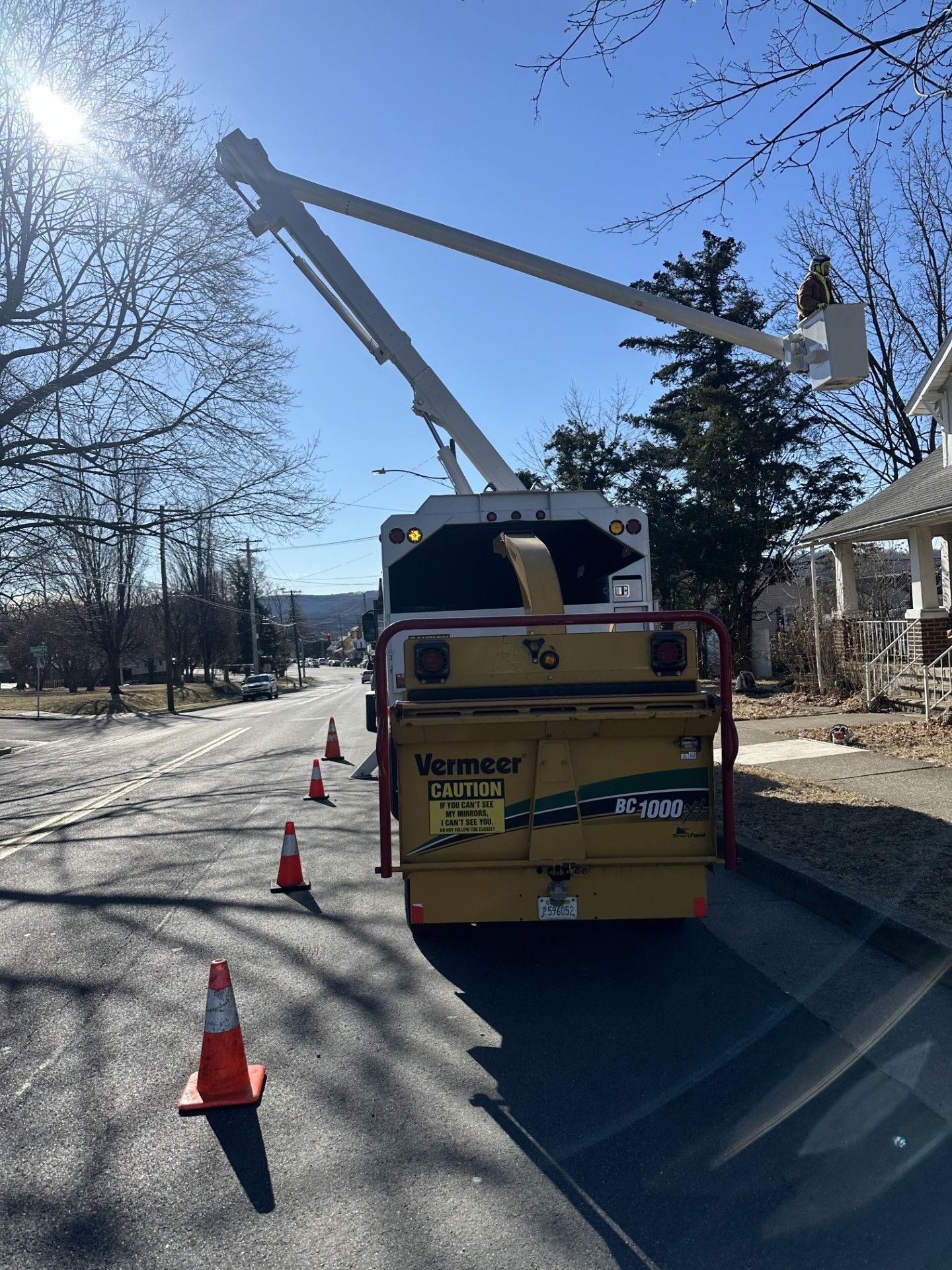 A large yellow truck is parked on the side of the road.