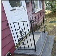 Front of Red house with Concrete Stairs.