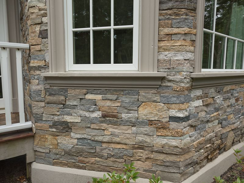 A house with a stone wall and a window