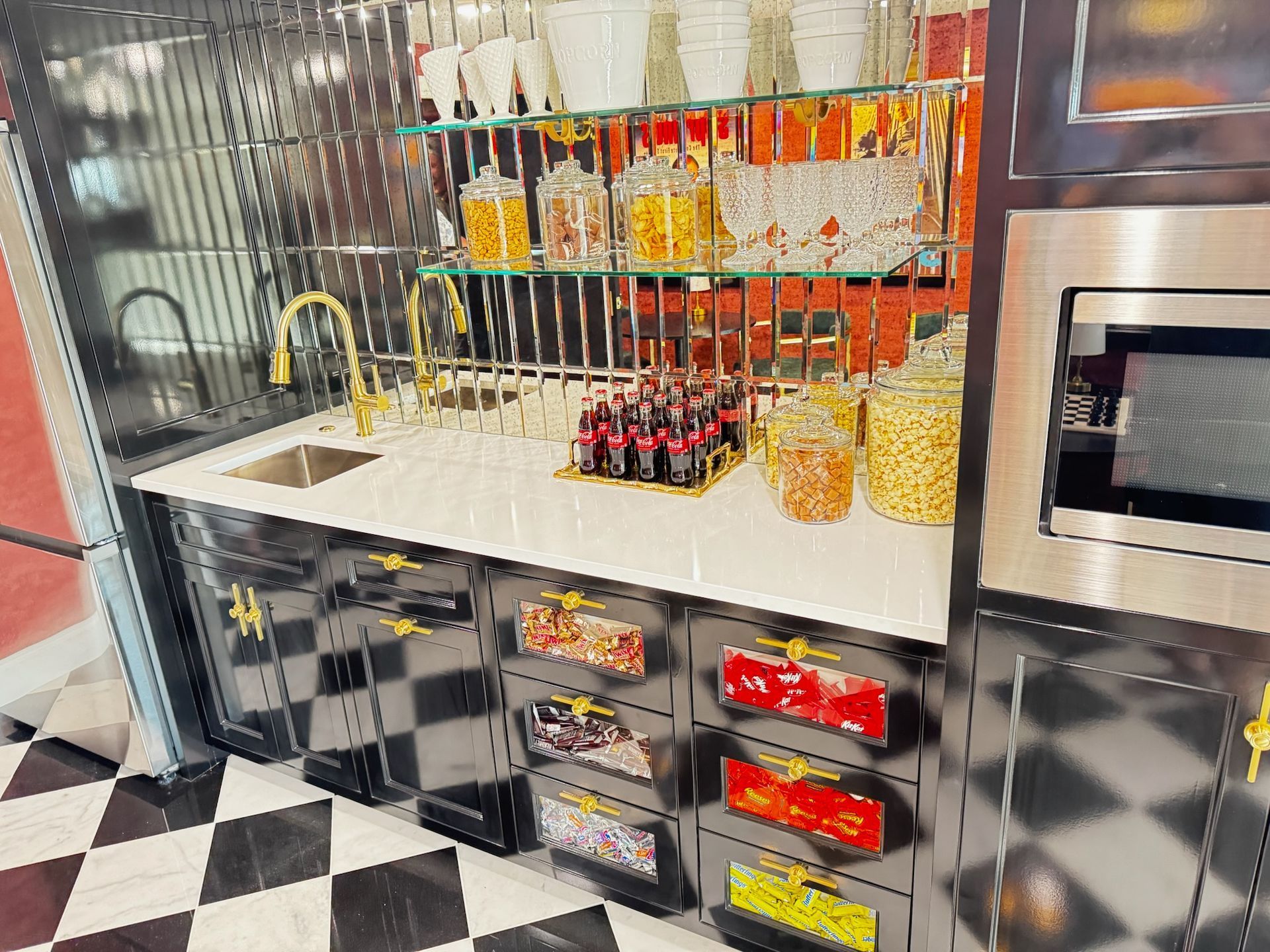 A kitchen area with a sink, microwave, and cabinets