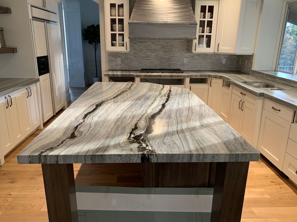 There is a large island in the middle of the kitchen.
