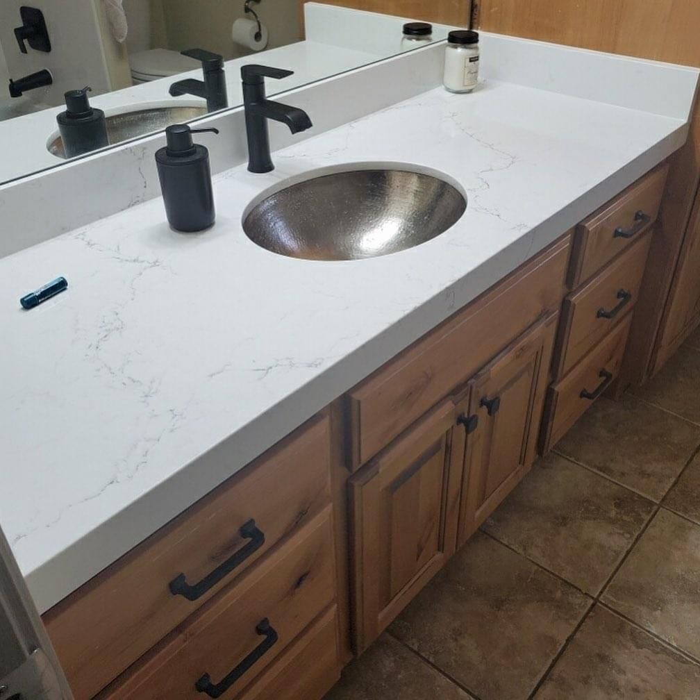 A bathroom vanity with a sink and a mirror.