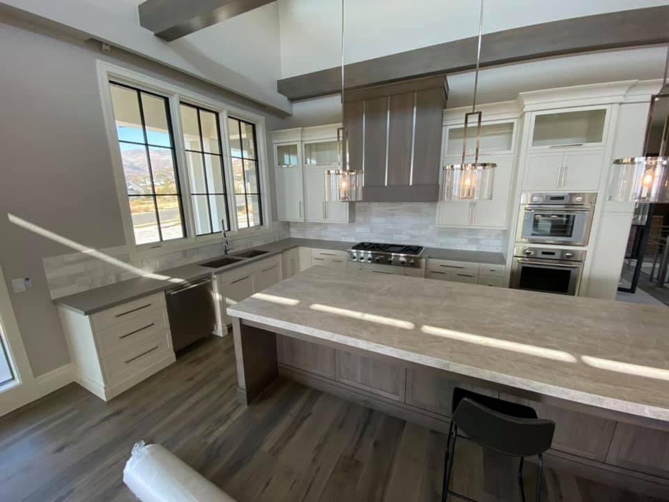 A kitchen with a large island and stainless steel appliances.
