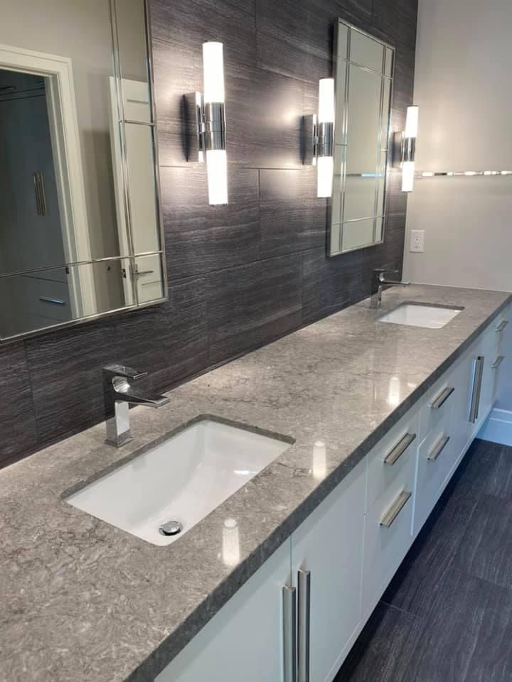 A bathroom with two sinks and two mirrors.