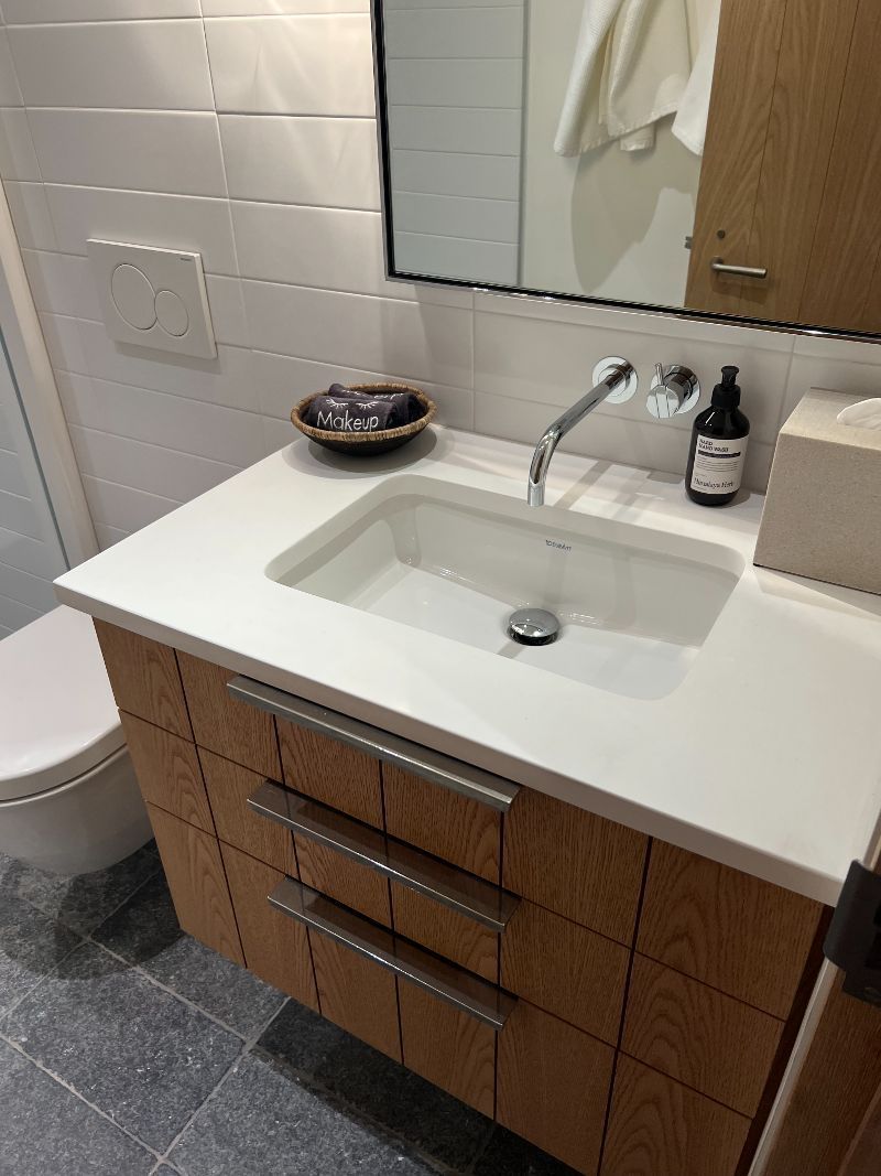 A bathroom with a sink , toilet and mirror