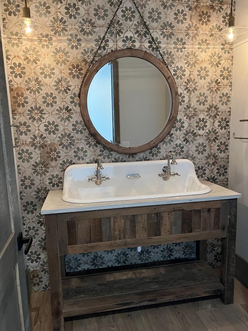 A bathroom with a sink and a mirror on the wall.