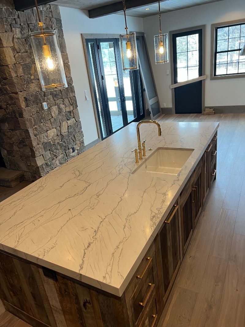 A kitchen with a large island and a sink.
