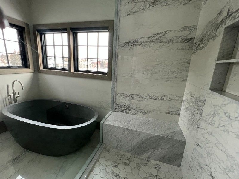 A bathroom with a bathtub and a shower.