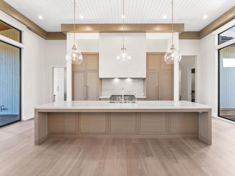 There is a large island in the middle of the kitchen.