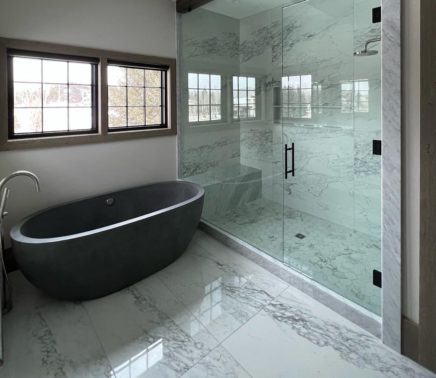 A bathroom with a bathtub and a walk in shower.