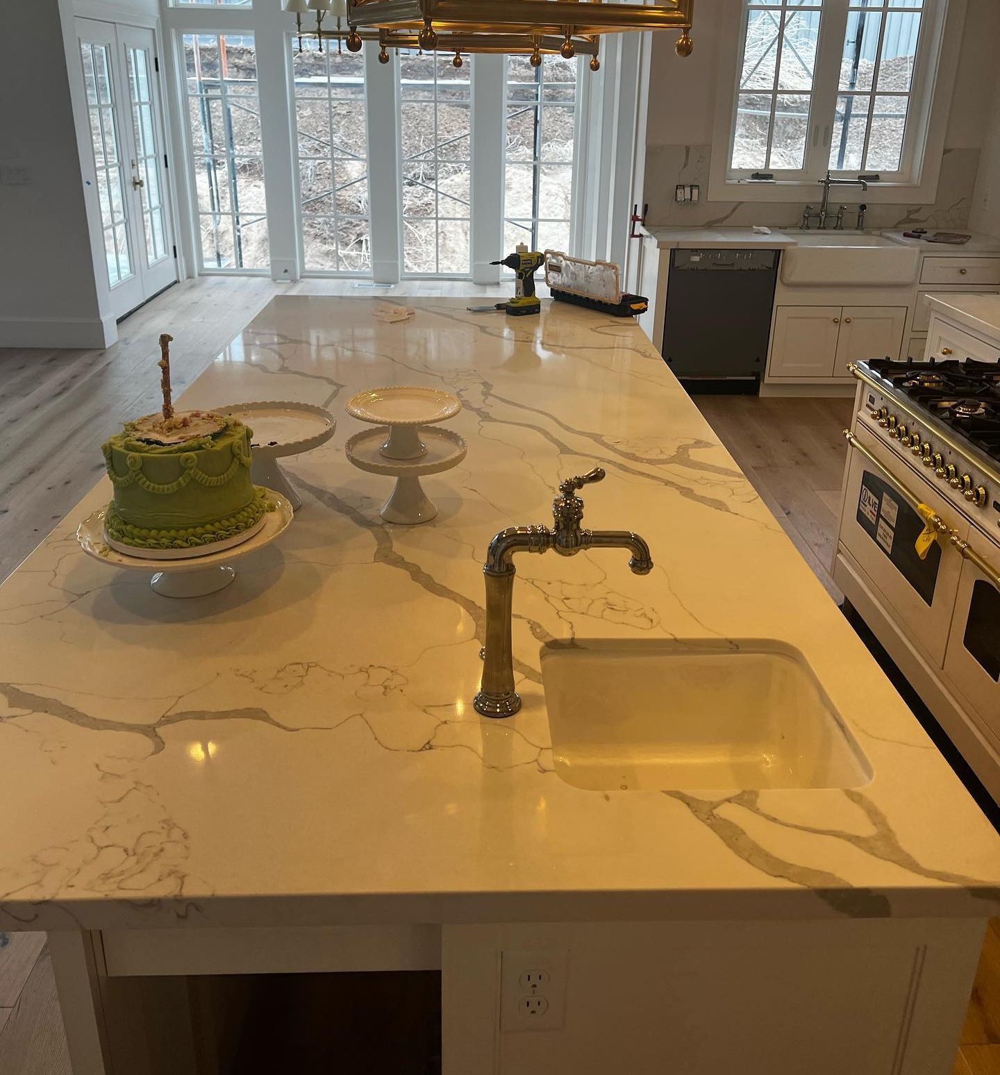 A kitchen island with a sink and a cake on it